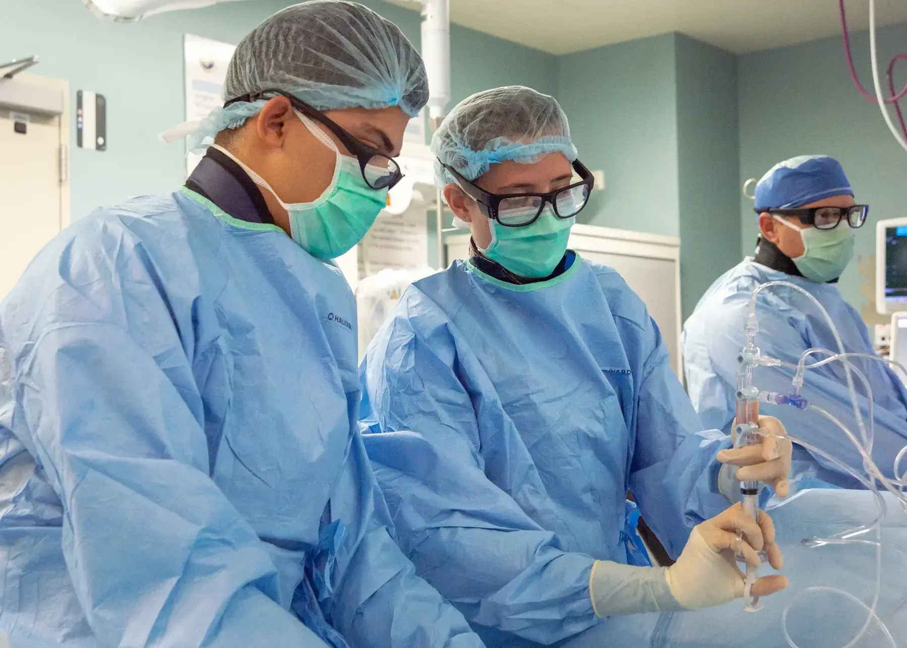 Clinical team performing a cardiac catheterization procedure in a controlled laboratory